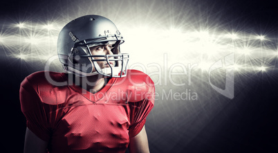 Composite image of american football player looking away while s