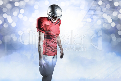 Composite image of american football player with ball looking do