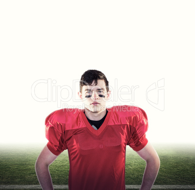 Composite image of serious american football player looking at c