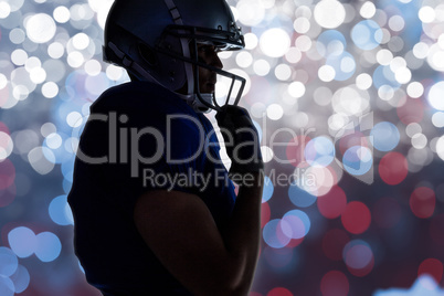 Composite image of side view of silhouette american football pla