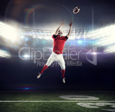 Composite image of american football player trying to catch foot