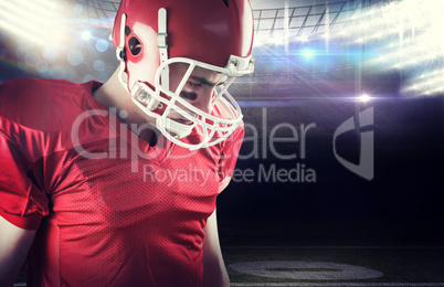 Composite image of american football player taking his helmet on