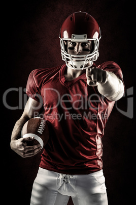 Composite image of american football player pointing at camera