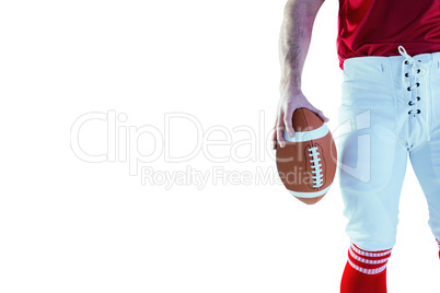 American football player holding up football