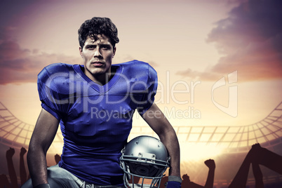 Composite image of portrait of serious sportsman with hand on kn