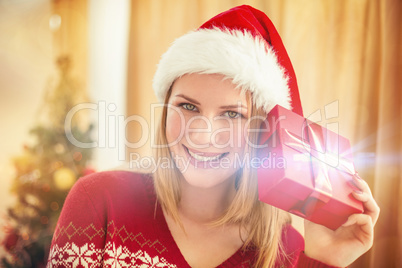 Festive blonde holding a gift