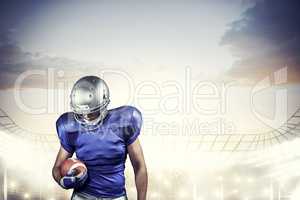 Composite image of american football player looking down while h
