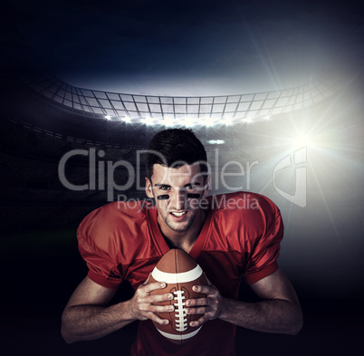 Composite image of portrait of serious player holding rugby ball