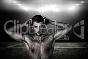 Composite image of portrait of a shirtless man holding ball over