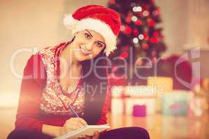 Festive brunette writing her list