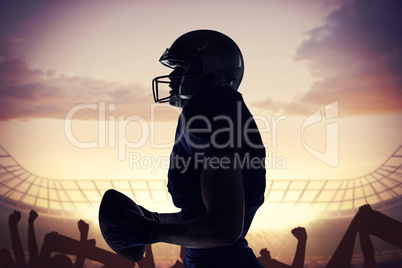 Composite image of side view of sportsman holding football Composite image of side view of sportsman holding football