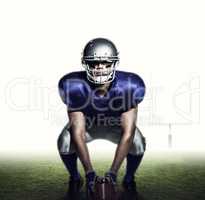 Composite image of american football player with ball crouching