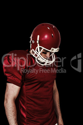 Composite image of unsmiling american football player looking do