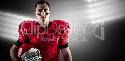 Composite image of a serious american football player looking at