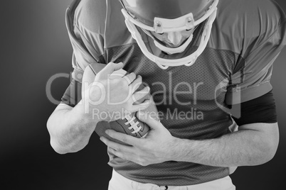 American football player protecting football