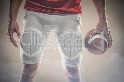 Composite image of sports player holding ball