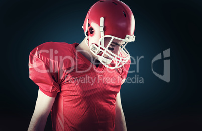 Composite image of a football player taking his helmet on her he