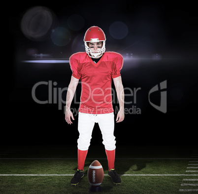 Composite image of serious american football player looking at c