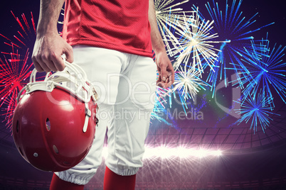 Composite image of an american football player taking his helmet