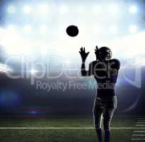 Composite image of american football player catching ball