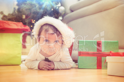 Cute baby boy lying on floor at christmas