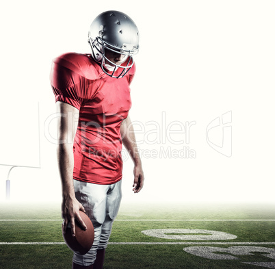 Composite image of american football player with ball looking do