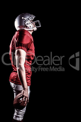 Composite image of american football player looking up while sta