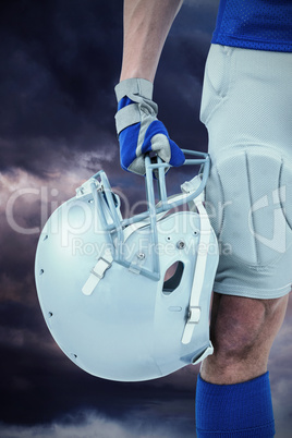 Composite image of close-up of american football player holding Composite image of close-up of american football player holding