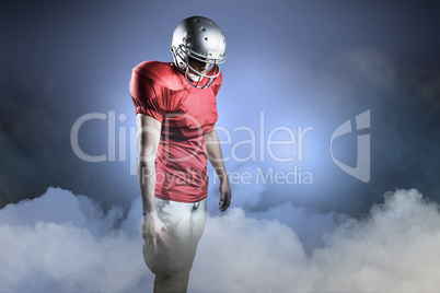 Composite image of american football player with ball looking do