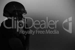Side view of silhouette American football player wearing helmet