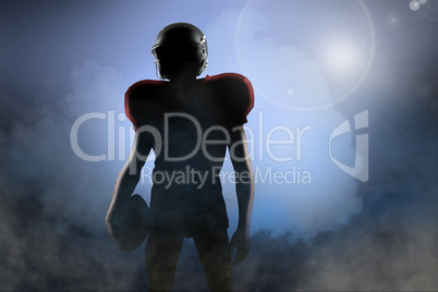Composite image of american football player in red jersey lookin Composite image of american football player in red jersey lookin