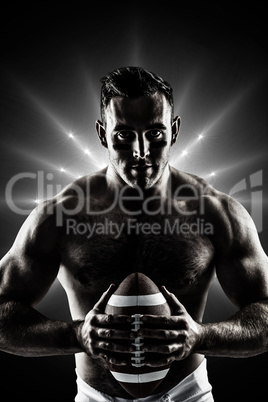 Composite image of shirtless american football player with ball