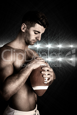 Composite image of shirtless rugby player holding the ball