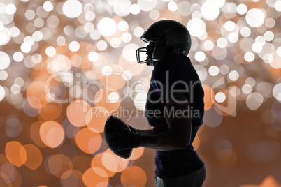 Composite image of side view of sportsman holding football