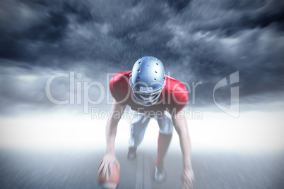 Composite image of american football player taking position whil