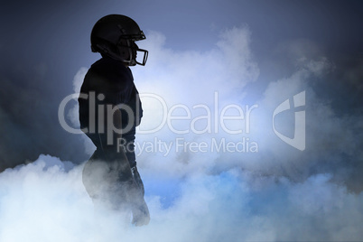 Composite image of side view of silhouette american football pla