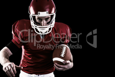Composite image of portrait of focused american football player being ready to attack