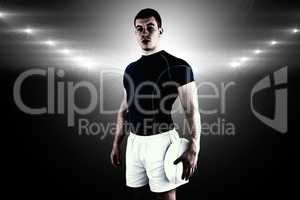 Composite image of rugby player holding rugby ball