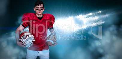 Composite image of american football player holding helmet and a