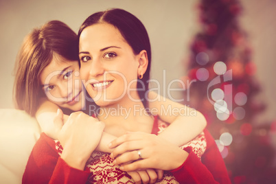 Festive mother and daughter smiling at camera