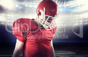 Composite image of a football player taking his helmet on her he