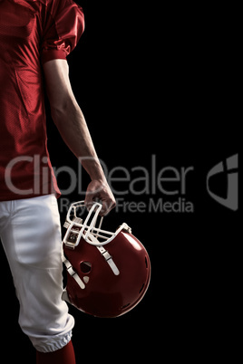 Composite image of an american football player taking his helmet