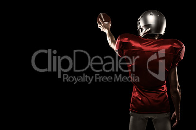 Composite image of rear view of sport player in red jersey holding ball