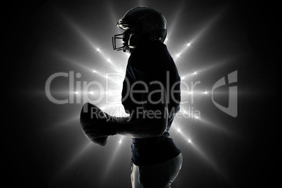 Composite image of side view of sportsman holding football Composite image of side view of sportsman holding football