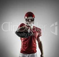 Composite image of american football player showing ball