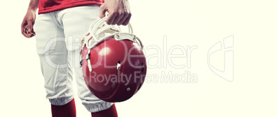 Composite image of an american football player taking his helmet