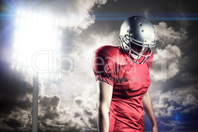 Composite image of american football player with ball looking do