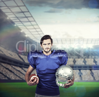 Composite image of confident american football player holding an