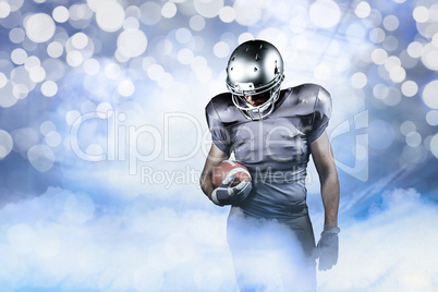 Composite image of american football player looking down while h