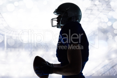 Composite image of side view of sportsman holding football